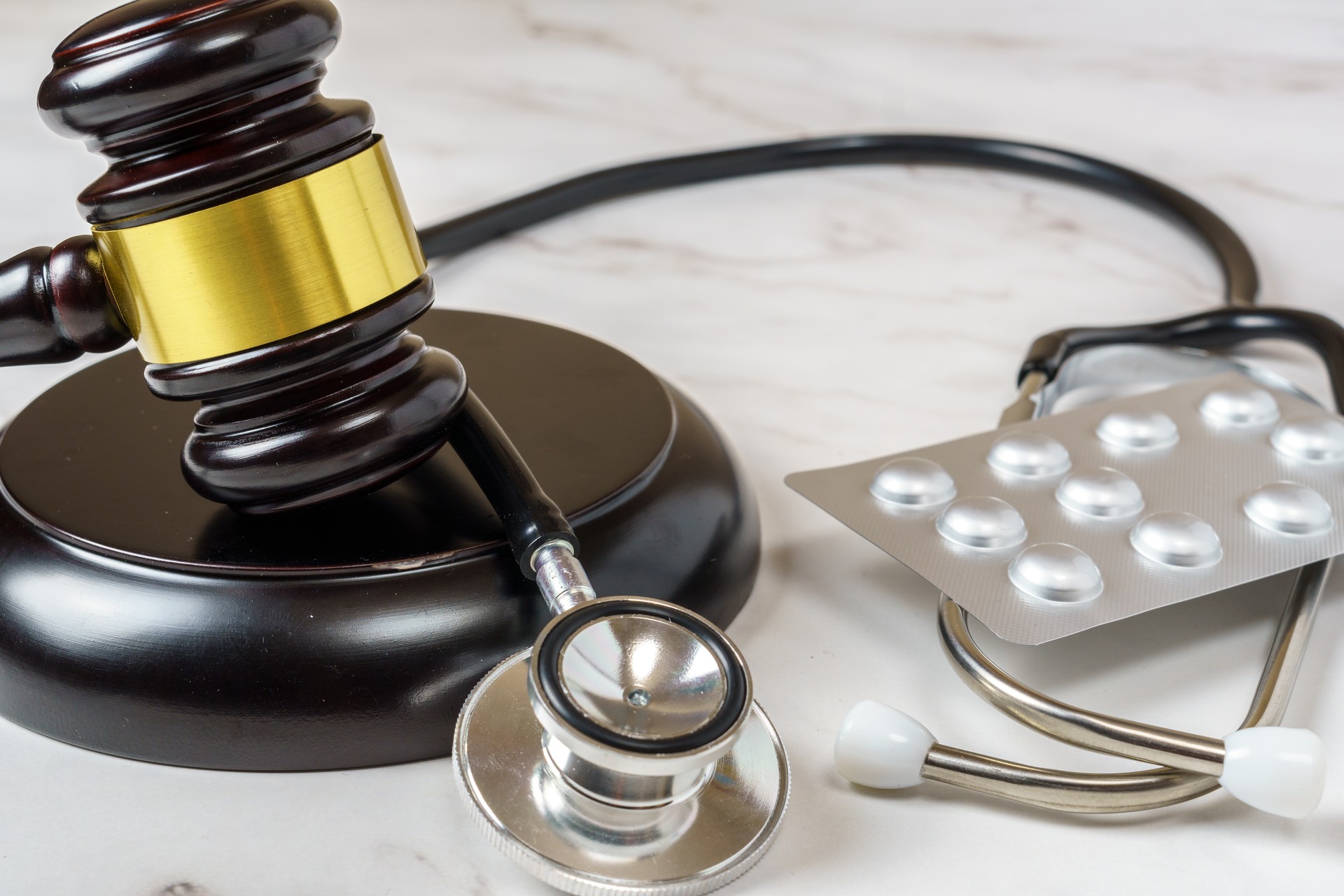 judge's gavel and a professional stethoscope representing legal decisions in health care. The intersection of law and medicine